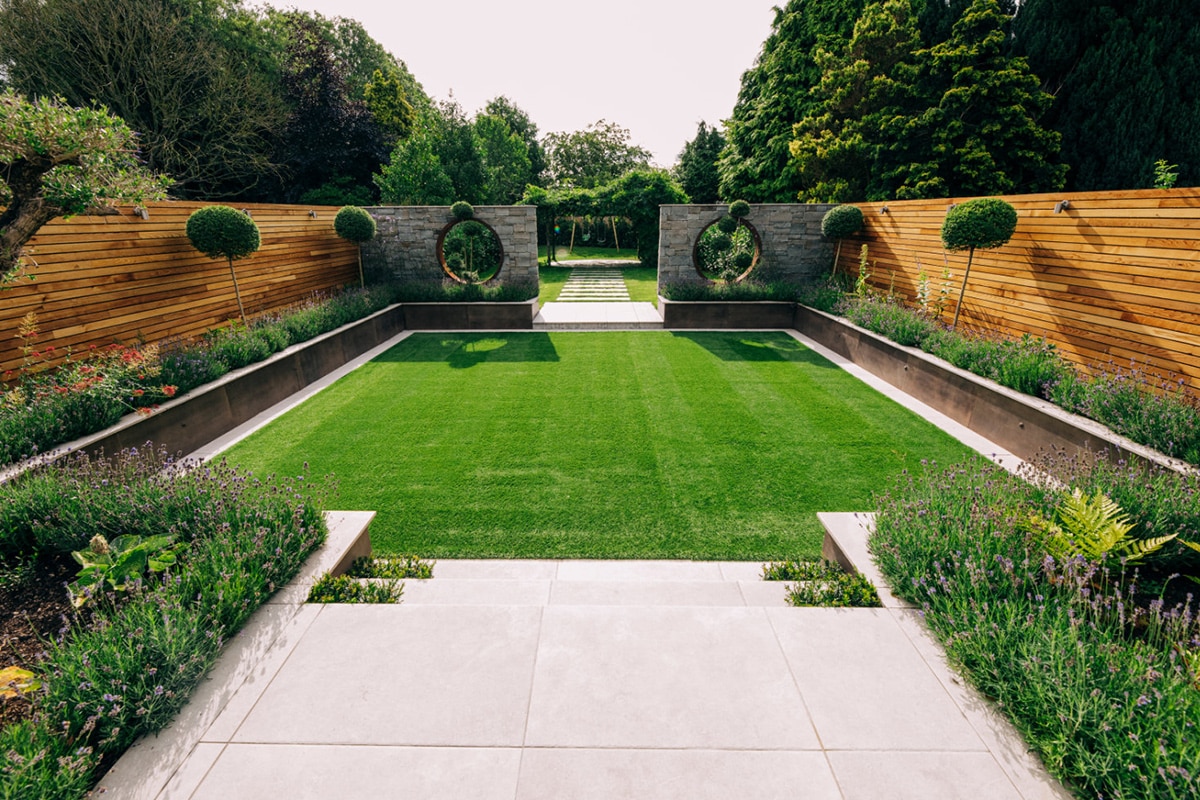 Formal landscaped UK garden with striped lawn