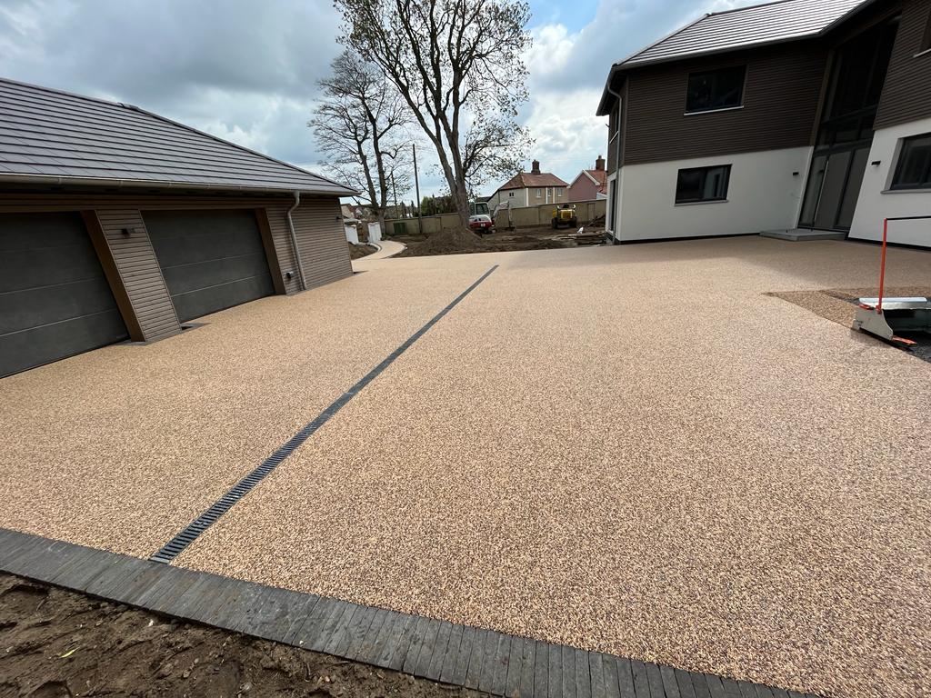 Golden resin bound driveway with double garage